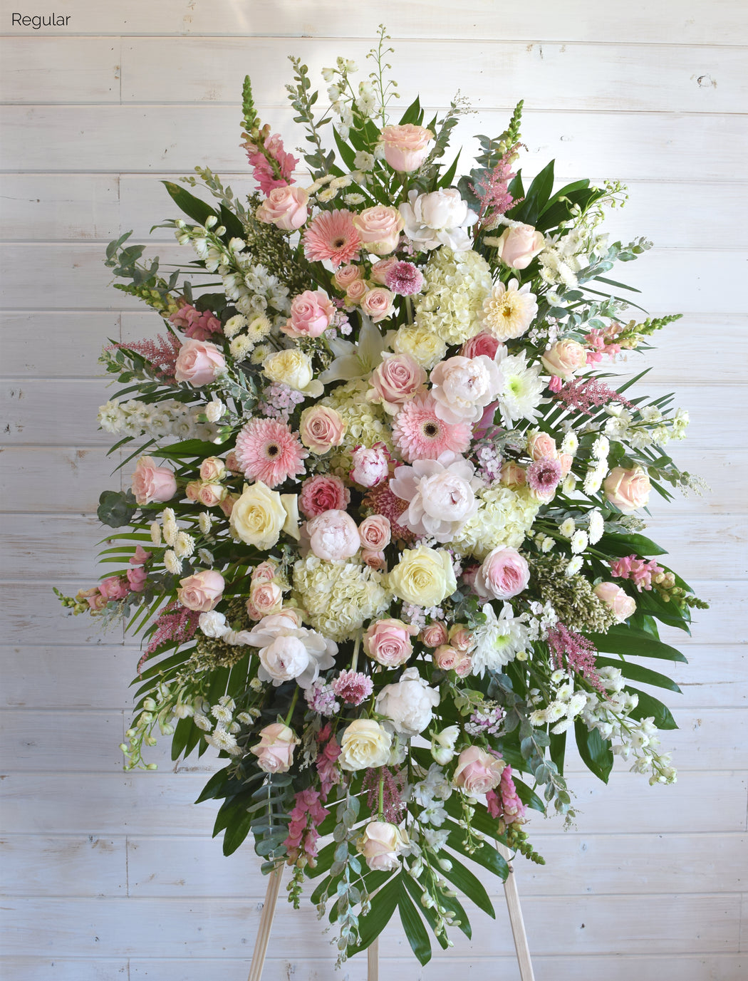 Deluxe Remembrance Stand with pink and ivory roses, hydrangea, gerbera daisies, dahlias, and seasonal blooms in a stunning standing spray for memorials.